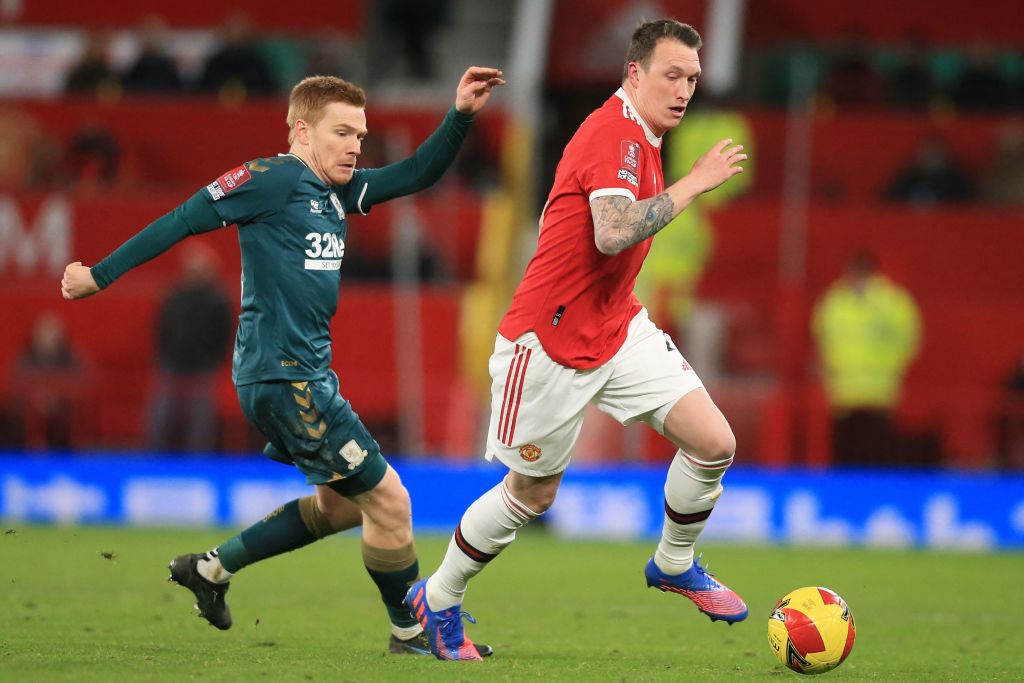 Manchester United's English defender Phil Jones (R) vies with Middlesbrough's English striker Duncan Watmore (L)